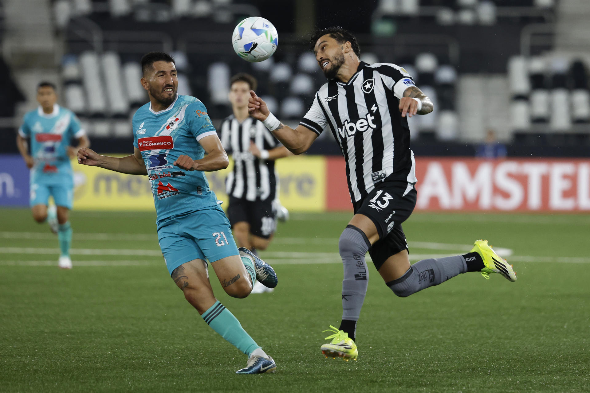 Alex Telles (d), de Botafogo, disputa un balón con Óscar Baldomar, de Nacional Potosí, en el partido de vuelta de la segunda fase de clasificación de la Copa Libertadores entre Botafogo y Nacional Potosí en el estadio Olímpico Nilton Santos en Río de Janeiro (Brasil). EFE/Antonio Lacerda