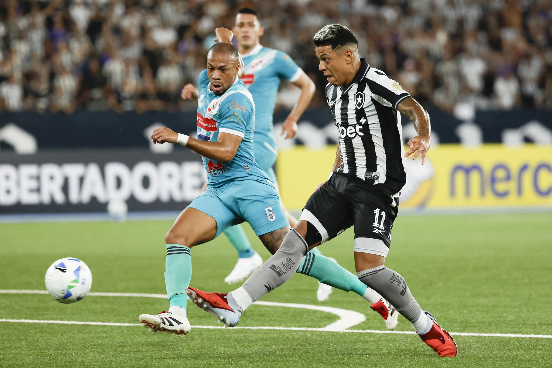 Matheus Martins (d), de Botafogo, disputa un balón con Edisson Restrepo, de Nacional Potosí, en el partido de vuelta de la segunda fase de clasificación de la Copa Libertadores entre Botafogo y Nacional Potosí en el estadio Olímpico Nilton Santos en Río de Janeiro (Brasil). EFE/Antonio Lacerda