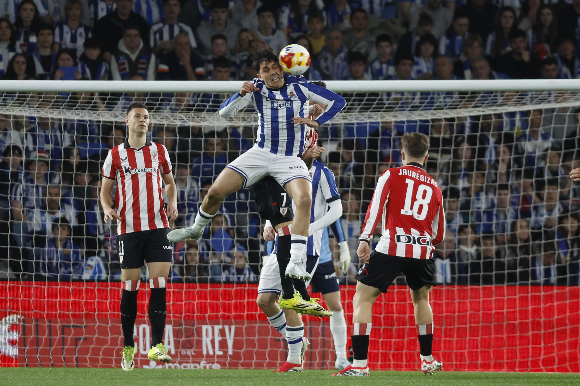 El defensa de la Real Sociedad, Jon Aramburu , disputa el balón ante el delantero del Athletic Club, Berenguer, durante el encuentro correspondiente a la vuelta de las semifinales de la Copa del Rey que disputan Real Sociedad y Athletic Club en el estadio de Anoeta, en San Sebastián. EFE / Javier Etxezarreta.